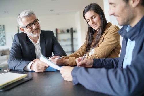 Mandataire immobilier independant - Un couple signe l'achat d'un bien en la compagnie d'un mandataire immobilier
